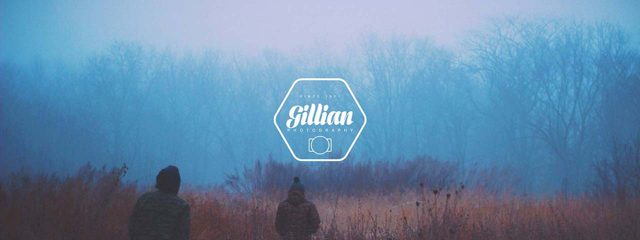Two people walking in foggy field.